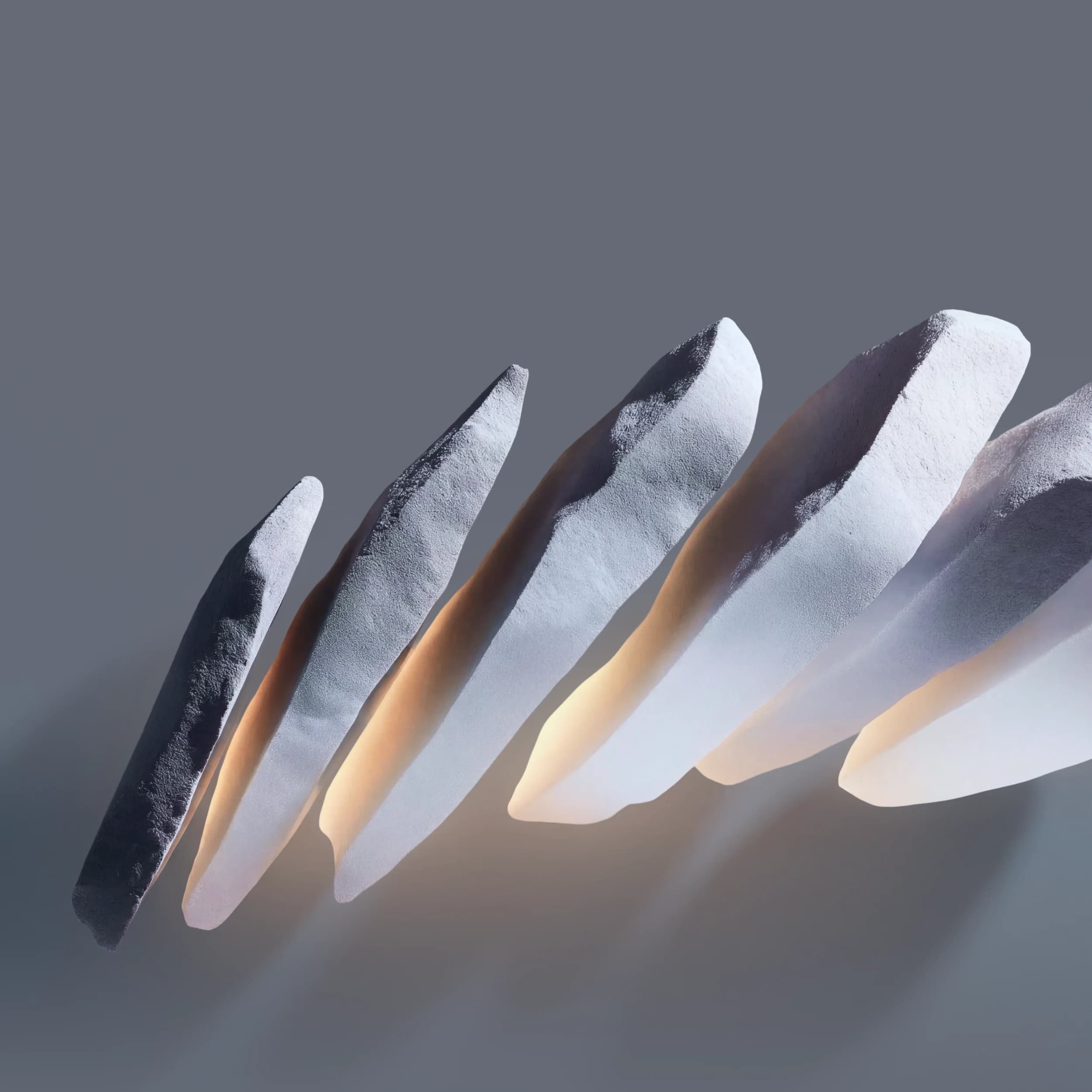 Pale, faceted stone forms lit warmly from within against a slate-grey ground