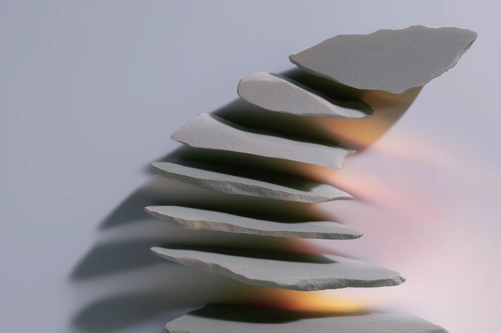 Thin stone slabs stacked in a rising stair, warm light glowing between the layers